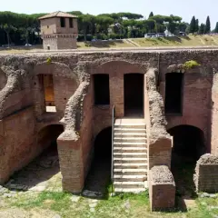 Antiche rovine romane vicino alla fermata metro Circo Massimo. Una scala conduce a un ingresso ad arco.
