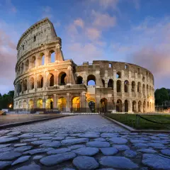 Il Colosseo, uno dei più maestosi monumenti di Roma, illuminato al tramonto con un cielo suggestivo.
