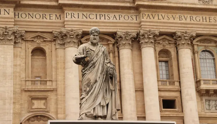 Statua di San Pietro davanti alla Basilica. La scritta "IN HONOREM PRINCIPIS APOST PAVLSV-BVRGHESIVS" celebra i santi Pietro e Paolo.